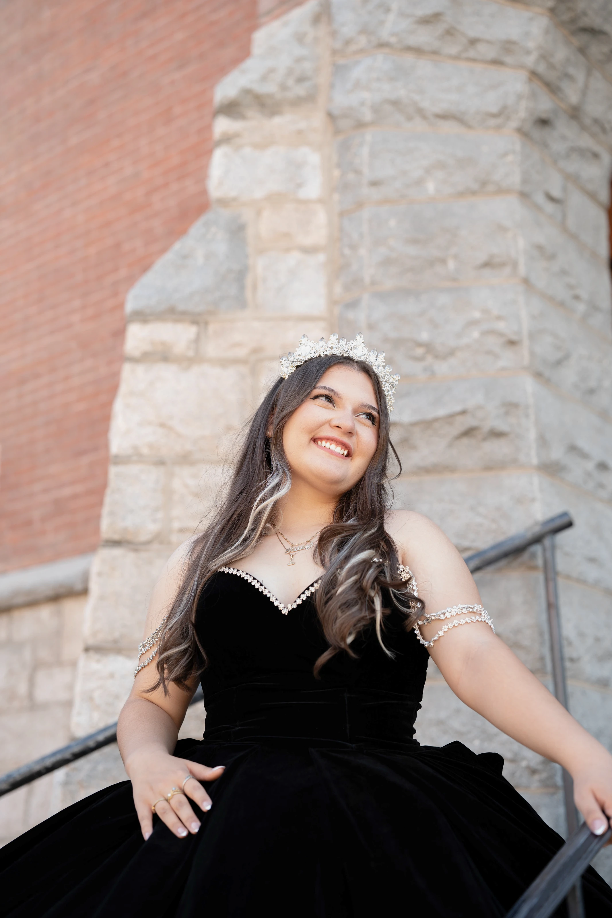 She smiles on the church steps, her crown catching the light